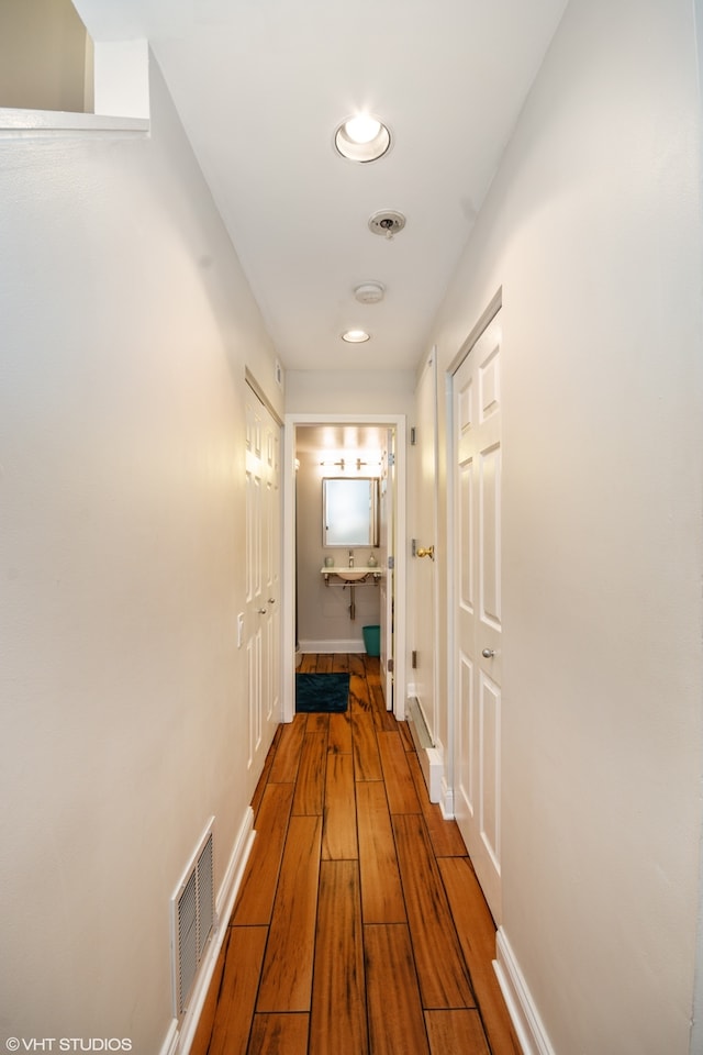 corridor featuring hardwood / wood-style floors