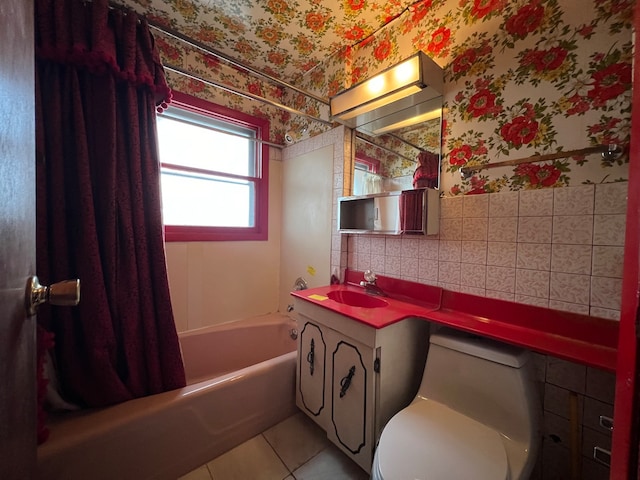 full bathroom featuring shower / tub combo, tile patterned floors, vanity, tile walls, and toilet