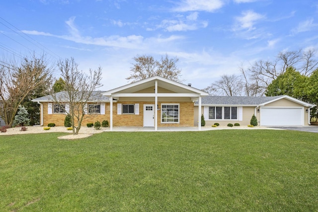 ranch-style house featuring a garage, covered porch, and a front lawn