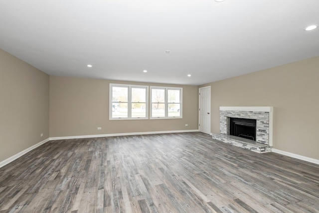 unfurnished living room with a fireplace and wood-type flooring