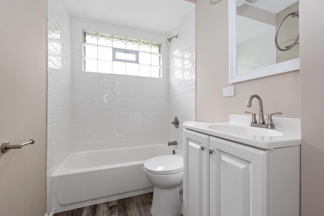 full bathroom with vanity, toilet, wood-type flooring, and tiled shower / bath combo