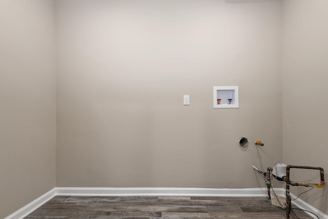 clothes washing area with dark hardwood / wood-style flooring and washer hookup