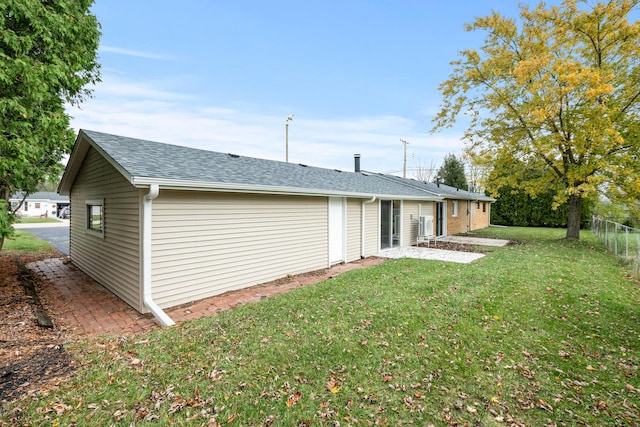 rear view of property featuring a lawn