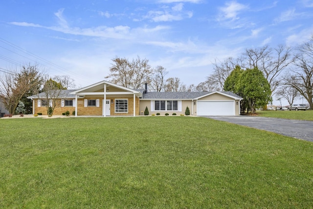 ranch-style home with covered porch, a garage, and a front yard