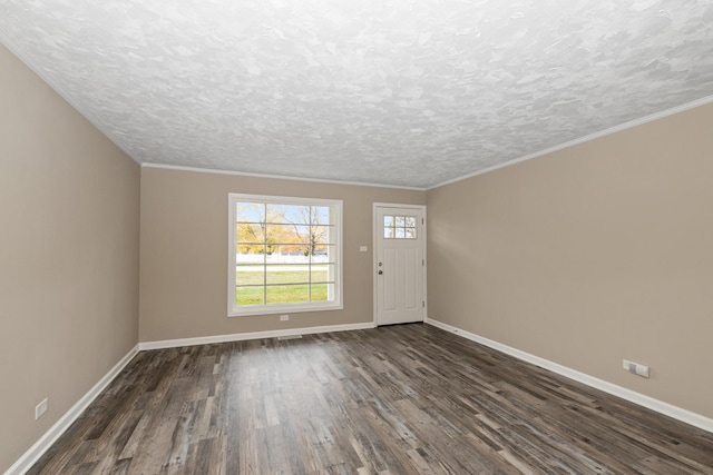 entryway featuring crown molding, dark wood-type flooring, and a textured ceiling