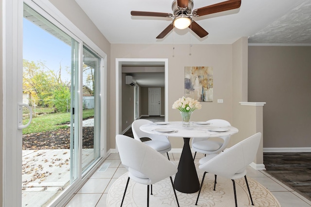 tiled dining room featuring a wall mounted AC, ceiling fan, and crown molding