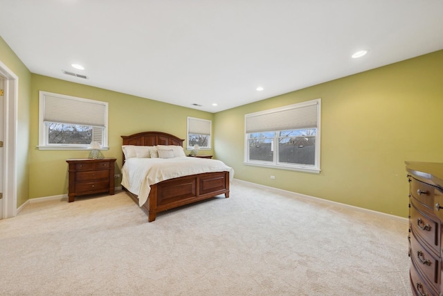 carpeted bedroom featuring multiple windows