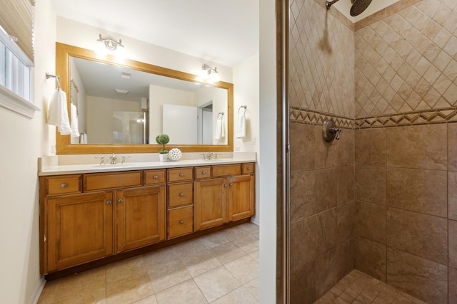 bathroom featuring tiled shower, vanity, and tile patterned floors