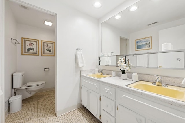 bathroom with vanity, tile patterned floors, and toilet