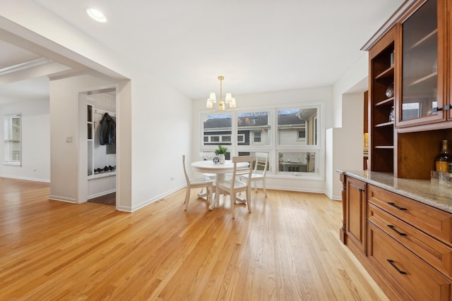 dining space with an inviting chandelier, light hardwood / wood-style flooring, and a healthy amount of sunlight