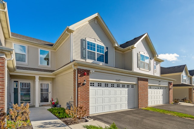 townhome / multi-family property featuring a garage