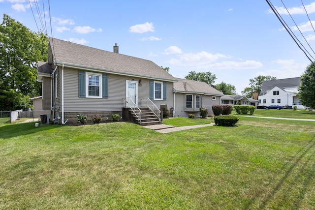 view of front facade featuring a front yard and cooling unit