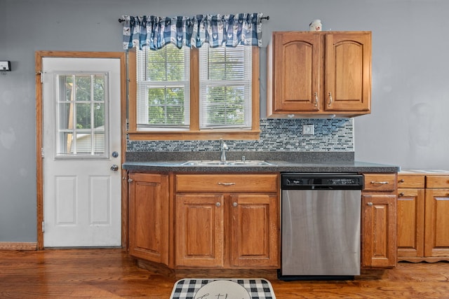 kitchen featuring tasteful backsplash, dark wood-type flooring, sink, and stainless steel dishwasher