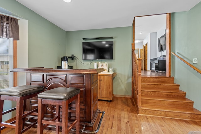 bar featuring light hardwood / wood-style floors