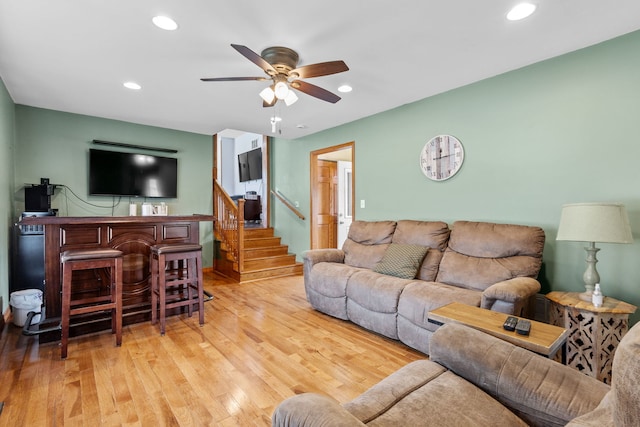 living room with ceiling fan and light wood-type flooring