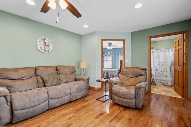 living room featuring ceiling fan and hardwood / wood-style floors