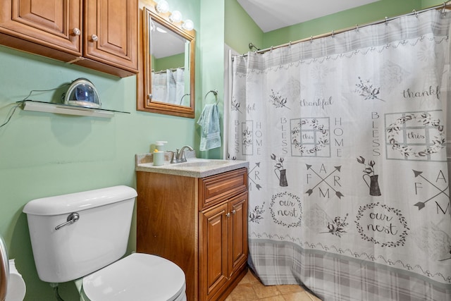 bathroom featuring a shower with shower curtain, vanity, toilet, and tile patterned floors