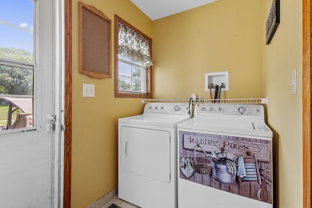 clothes washing area featuring a healthy amount of sunlight and independent washer and dryer