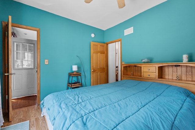 bedroom featuring light wood-type flooring and ceiling fan