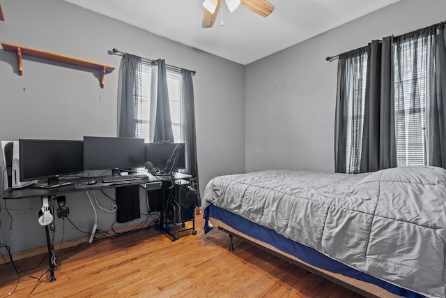 bedroom with hardwood / wood-style floors and ceiling fan