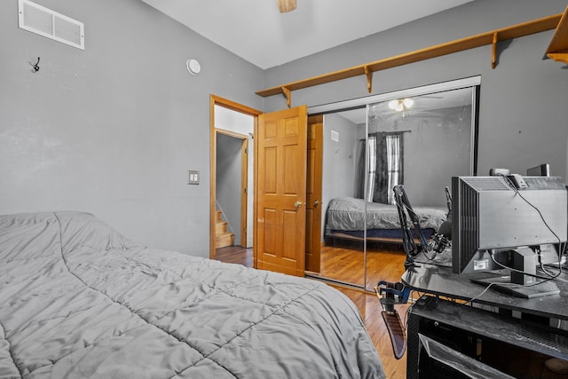 bedroom featuring hardwood / wood-style floors and a closet