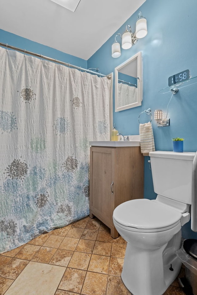 bathroom with vanity, toilet, and walk in shower