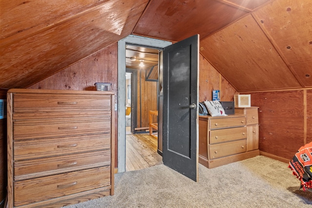 bonus room with light hardwood / wood-style flooring, lofted ceiling, and wood walls