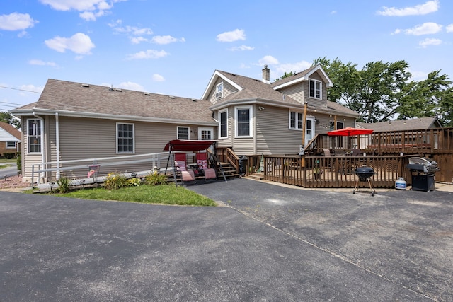 back of property featuring a deck