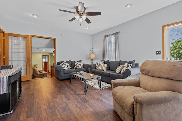 living room featuring dark hardwood / wood-style floors and ceiling fan