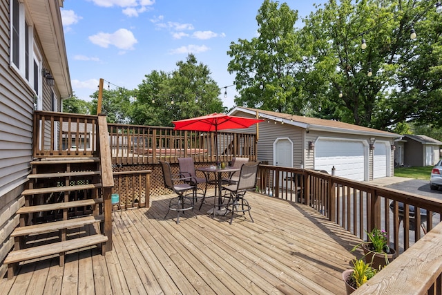 wooden terrace featuring an outdoor structure and a garage