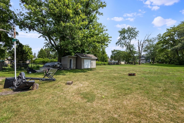 view of yard featuring a fire pit and a storage unit