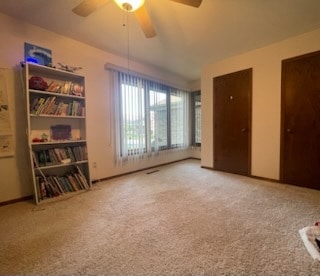 interior space with multiple closets and ceiling fan