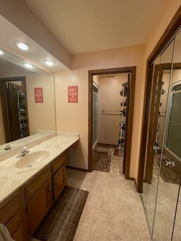 bathroom featuring vanity and an enclosed shower