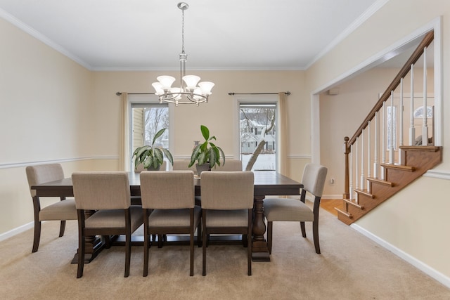 carpeted dining area featuring ornamental molding and an inviting chandelier