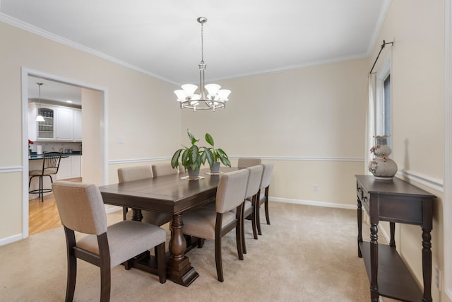 carpeted dining area featuring crown molding and a chandelier