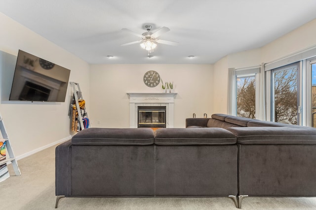 carpeted living room featuring ceiling fan