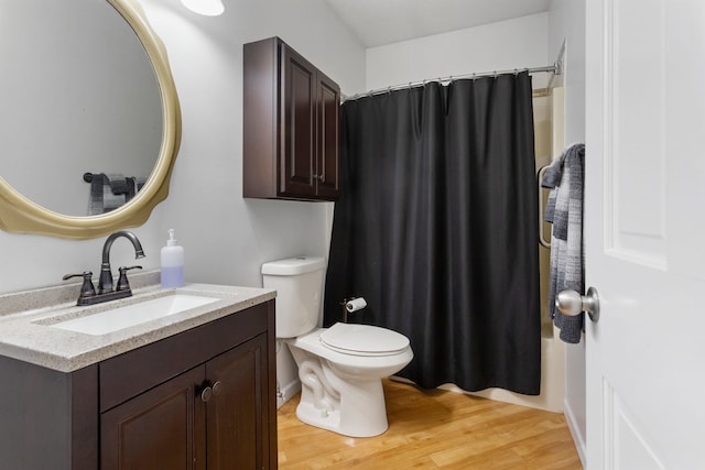 full bathroom with hardwood / wood-style flooring, vanity, toilet, and shower / bathtub combination with curtain