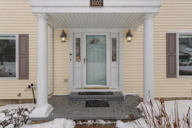 view of snow covered property entrance