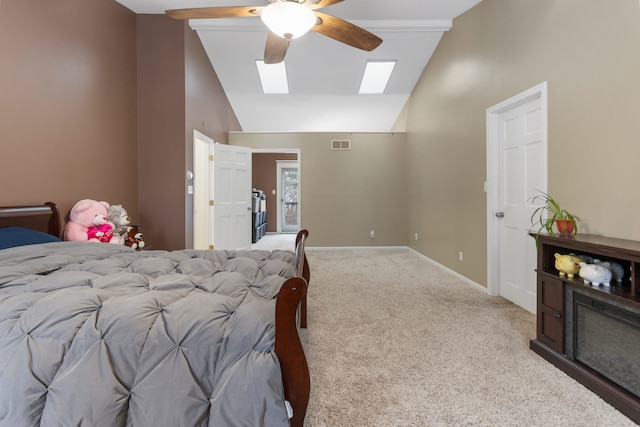 carpeted bedroom with a skylight, ceiling fan, and high vaulted ceiling