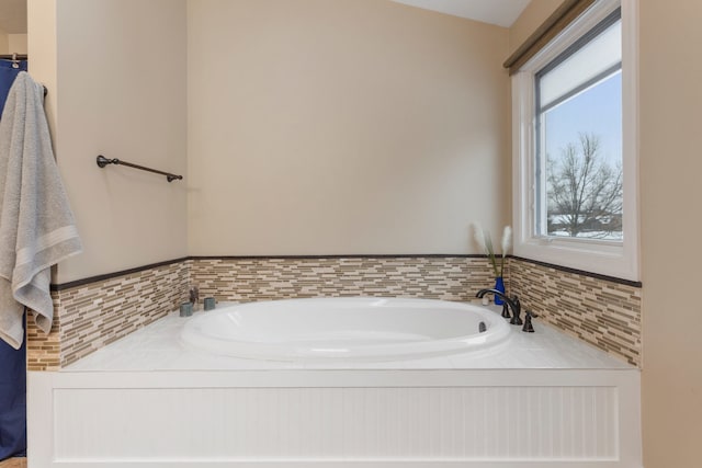 bathroom with a tub to relax in