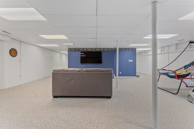 unfurnished living room featuring a drop ceiling