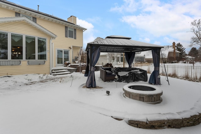 exterior space featuring a gazebo and a fire pit