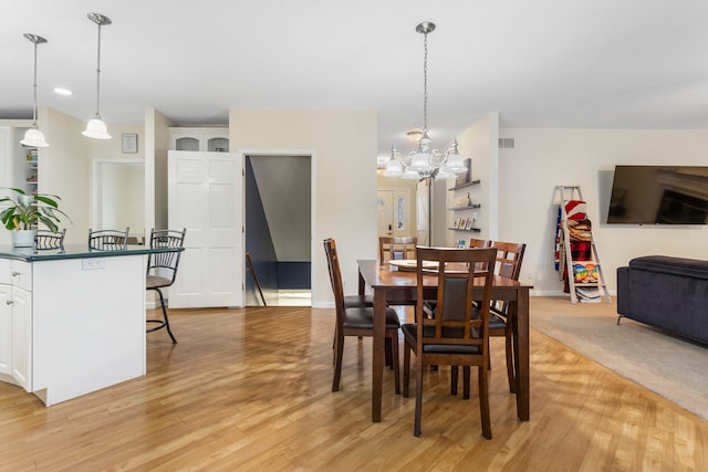 dining area featuring a chandelier and light hardwood / wood-style flooring