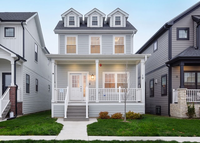 view of front of home featuring covered porch and a front lawn