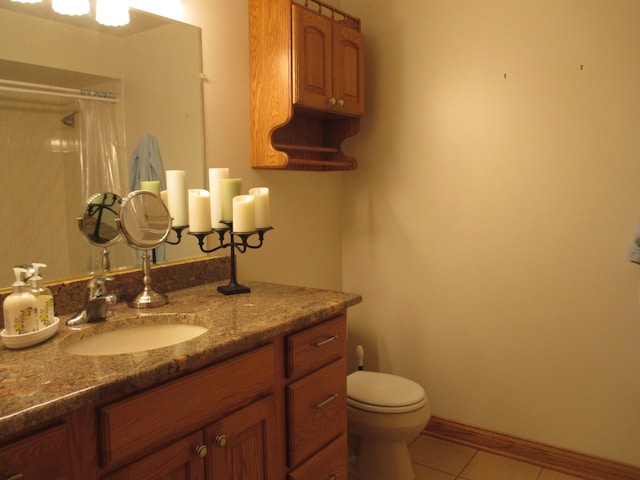 bathroom featuring tile patterned flooring, vanity, curtained shower, and toilet