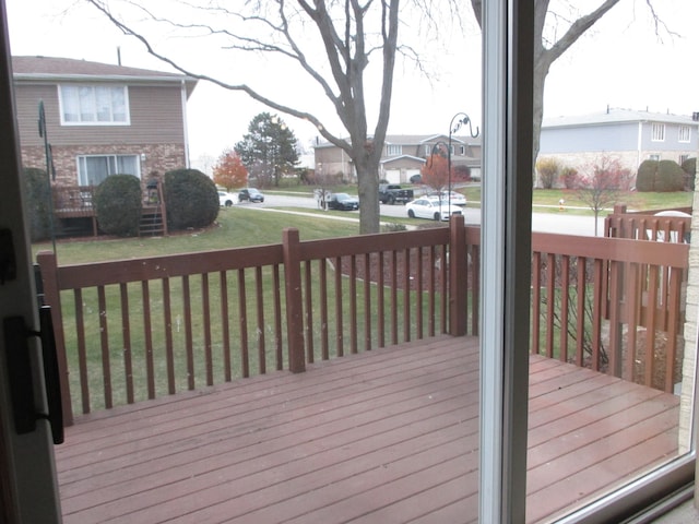 wooden terrace featuring a lawn