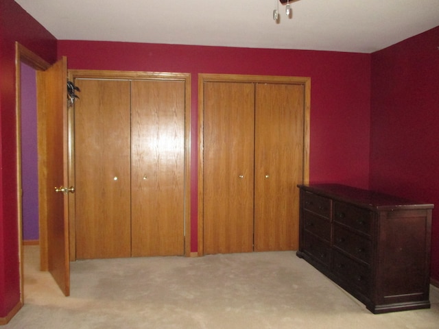 carpeted bedroom with multiple closets