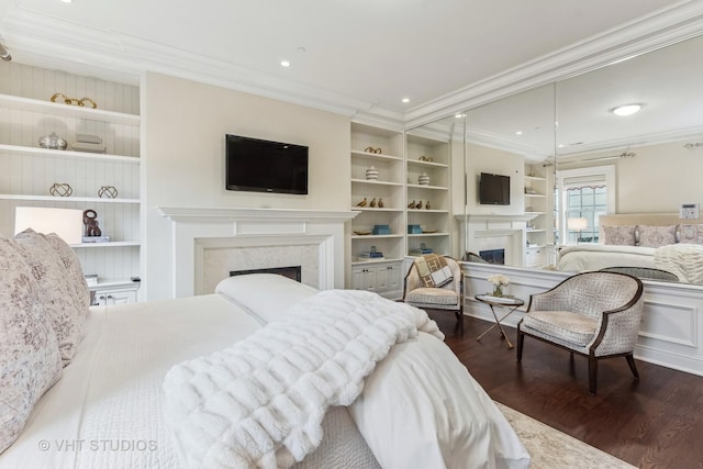 bedroom with a fireplace, dark wood finished floors, crown molding, and recessed lighting