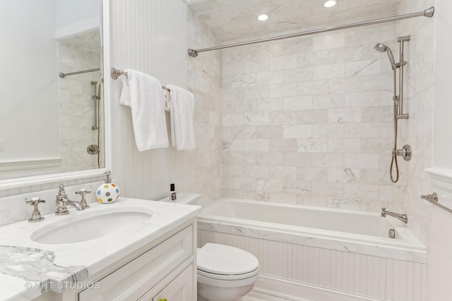 full bath featuring toilet, vanity, and bathing tub / shower combination