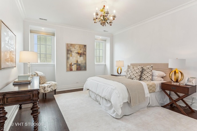 bedroom with baseboards, visible vents, ornamental molding, wood finished floors, and a notable chandelier